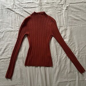 Reddish orange long sleeve turtle neck top